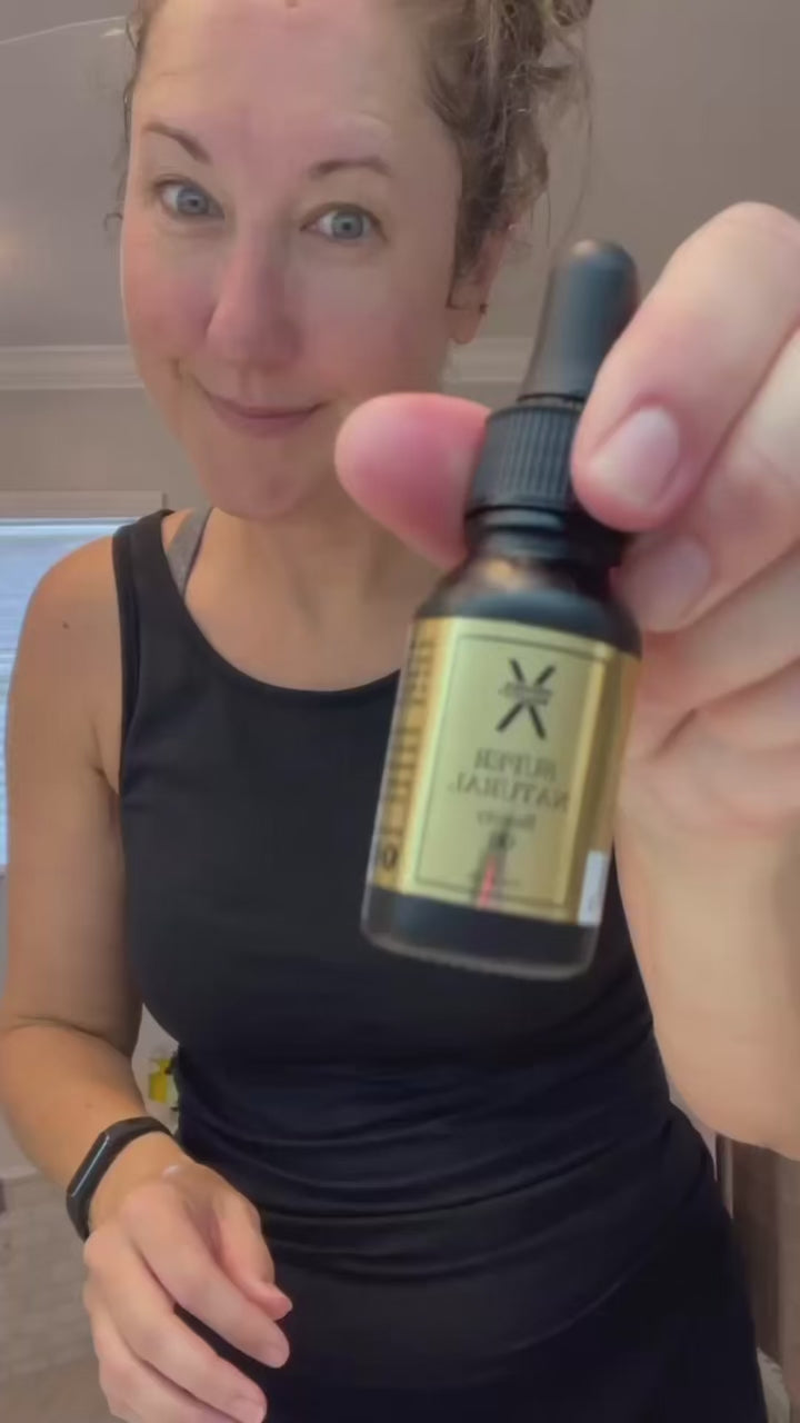 A video of a young woman showing Super Natural Beauty Oil benefits