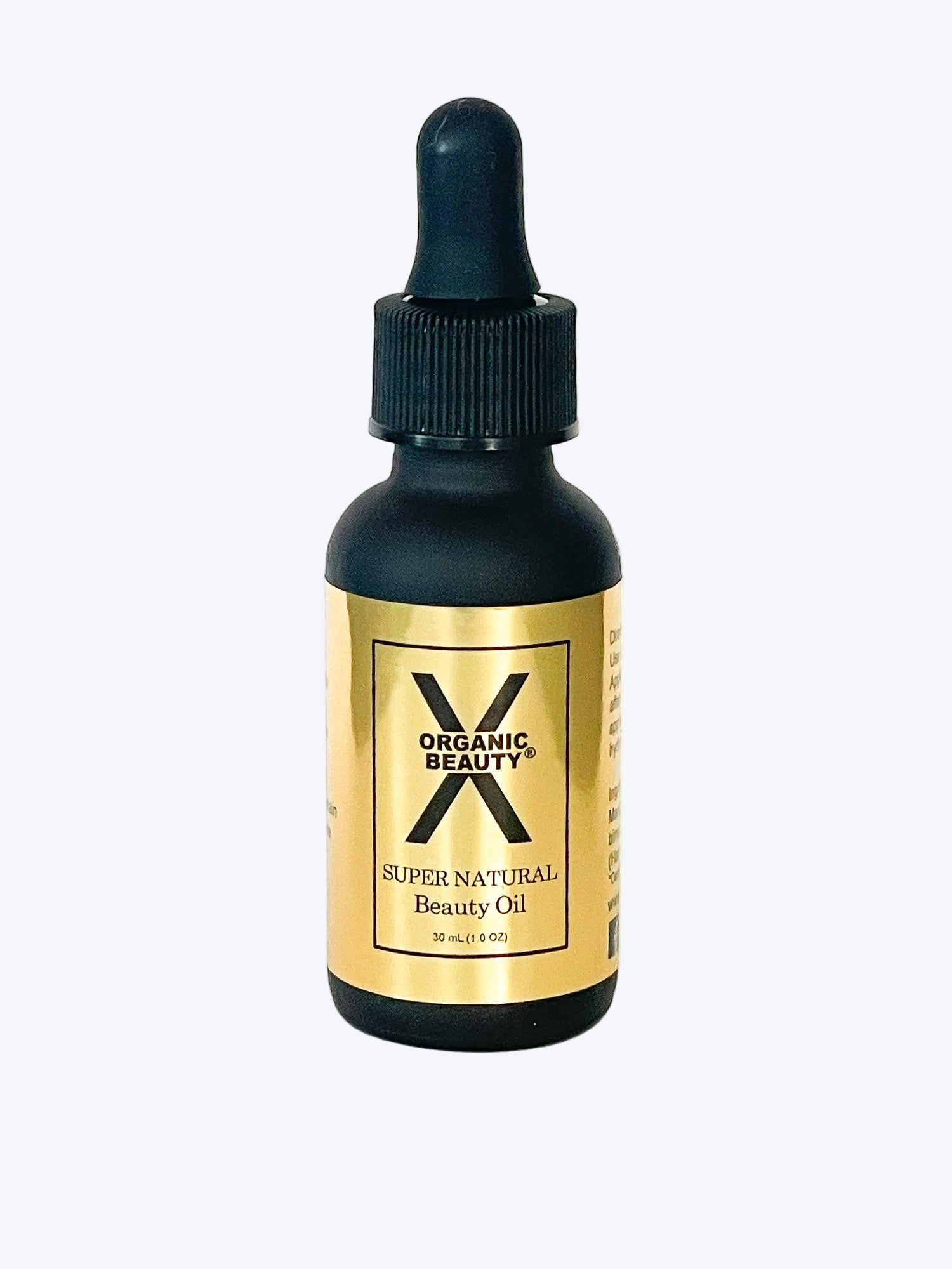 A one ounce bottle of X Organic Beauty's Super Natural Beauty Oil on a white background